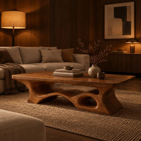 Thick slab coffee table with a carved cutout base in an evening living room with walnut wall paneling