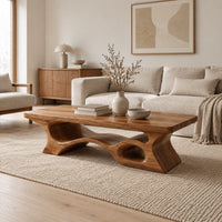 Thick slab coffee table with a carved cutout base in a Scandinavian living room with white walls