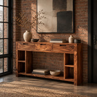 Console table with three drawers, open side cubbies and a lower shelf in an industrial loft entryway with exposed brick
