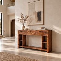 Console table with three drawers, open side cubbies and a lower shelf in a bright open plan entryway