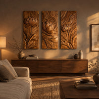 Set of three tall wooden panels carved with lotus flowers in relief above a low console in an evening living room
