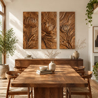 Set of three tall wooden panels carved with lotus flowers in relief in a bright sunroom with green plants