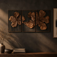 Three panel carved floral relief wall art with large petals on dark panels on a dark charcoal plaster wall