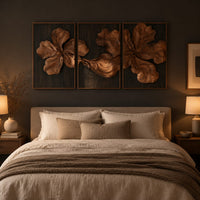 Three panel carved floral relief wall art with large petals on dark panels above a bed in a dusk lit bedroom