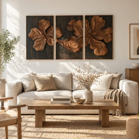 Three panel carved floral relief wall art with large petals on dark panels in a bright sunroom with green plants