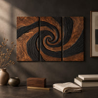 Detail of three panel spiral wall art with a carved black swirl on warm wood beside wood, brass and linen samples