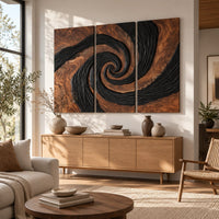 Three panel spiral wall art with a carved black swirl on warm wood above a light oak sideboard in daylight