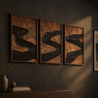 Set of three framed wood panels carved with a dark winding river, three-quarter view showing the carved depth