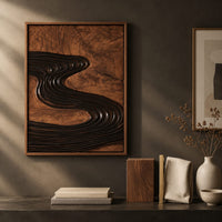 Detail of set of three framed wood panels carved with a dark winding river beside wood, brass and linen samples