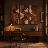 Three panel wall art with flowing bands of dark and light wood grain above a desk in a dark study corner