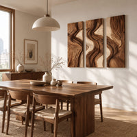 Three panel wall art with flowing bands of dark and light wood grain beside a dining table in natural light