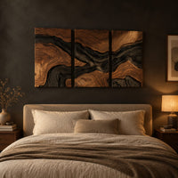 Three panel wood grain wall art with a dark flowing river band above a bed in a dusk lit bedroom