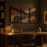 Three panel wood grain wall art with a dark flowing river band above a desk in a dark study corner