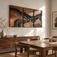 Three panel wood grain wall art with a dark flowing river band beside a dining table in natural light