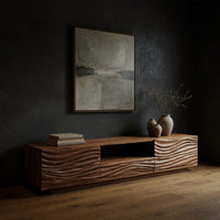 Media cabinet with wave carved doors around an open niche in a dark studio against a charcoal wall