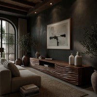 Media cabinet with wave carved doors around an open niche in a concrete and timber loft