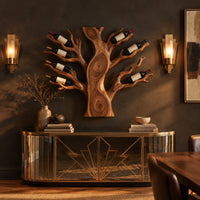 Carved tree shaped wine rack with a thick trunk and branches in a dark dining room at golden hour