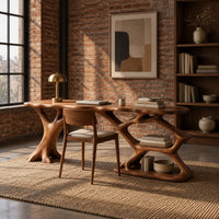 Desk with an oval top on a forked trunk leg and open branching shelves in an industrial loft home office with exposed brick