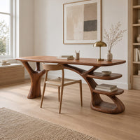 Wooden desk shaped like a tree with branching legs and two open shelves in a Scandinavian home office with white walls