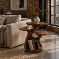 Tree shaped side table with three petal edged tops and a hollow trunk in an industrial loft living room with exposed brick