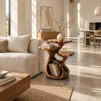 Tree shaped side table with three petal edged tops and a hollow trunk in a bright open plan living room