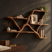 Corner detail of wall shelves in a branching limb shape with uneven tiers beside wood, brass and linen samples