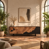 Low tv stand with tree ring carving, a dark wave panel and birds in a bright living room with arched windows and plants