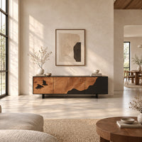 Low tv stand with tree ring carving, a dark wave panel and birds in a bright open plan living room