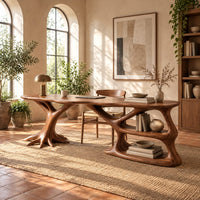 Desk with a tree root base, open shelves and an oval top in a bright home office with arched windows and plants
