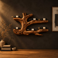 Tree root wine bottle holder with gnarled branching arms in a dark studio against a charcoal plaster wall