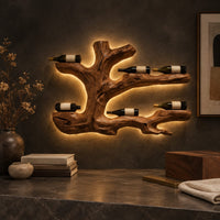 Corner detail of tree root wine bottle holder with gnarled branching arms beside wood, brass and linen samples