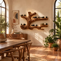 Tree root wine bottle holder with gnarled branching arms in a bright dining room with arched windows and plants