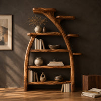 Corner detail of tree shaped bookshelf with an arched branch frame and four open shelves beside wood, brass and linen samples