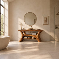 Bathroom vanity with forked trunk shaped legs and a low open shelf in a bright open plan bathroom