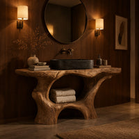 Tree trunk bathroom vanity with a natural edge top and open arched base in an evening bathroom with walnut wall paneling
