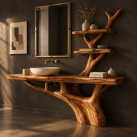 Corner detail of tree trunk bathroom vanity with a long slab top and a branch shelf tower beside wood, brass and linen samples