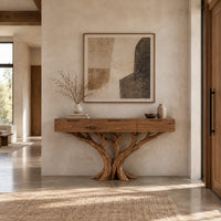 Console table with three drawers on a carved tree trunk base in a bright open plan entryway