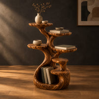 Tree shaped end table with scalloped tiers and a curled base nook in a dark studio against a charcoal plaster wall
