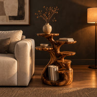 Tree shaped end table with scalloped tiers and a curled base nook in a dark living room at golden hour