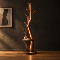 Tree shaped floor lamp with a glowing seam, short pegs and a tray in a dark studio against a charcoal plaster wall