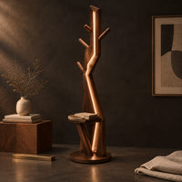 Corner detail of tree shaped floor lamp with a glowing seam, short pegs and a tray beside wood, brass and linen samples