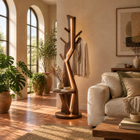 Tree shaped floor lamp with a glowing seam, short pegs and a tray in a bright living room with arched windows and plants