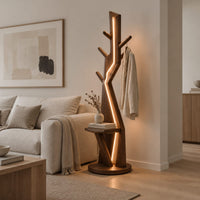 Tree shaped floor lamp with a glowing seam, short pegs and a tray in a Scandinavian living room with white walls