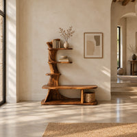 Tree trunk shoe bench with stepped shelves and an open lower base in a bright open plan entryway