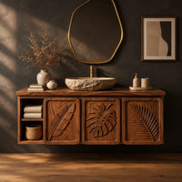 Bathroom vanity cabinet with three tropical leaf carved doors and an open shelf in a dark studio against a charcoal plaster wall
