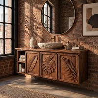 Bathroom vanity cabinet with three tropical leaf carved doors and an open shelf in an industrial loft bathroom with exposed brick