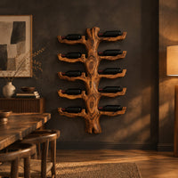 Trunk style wood wine rack with paired branch cradles in tiers in a dark dining room at golden hour