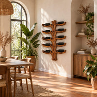 Trunk style wood wine rack with paired branch cradles in tiers in a bright dining room with arched windows and plants