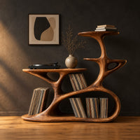 Branching tree form turntable stand with tiered shelves and oval cutouts in a dark studio against a charcoal plaster wall