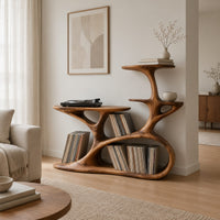 Branching tree form turntable stand with tiered shelves and oval cutouts in a Scandinavian living room with white walls